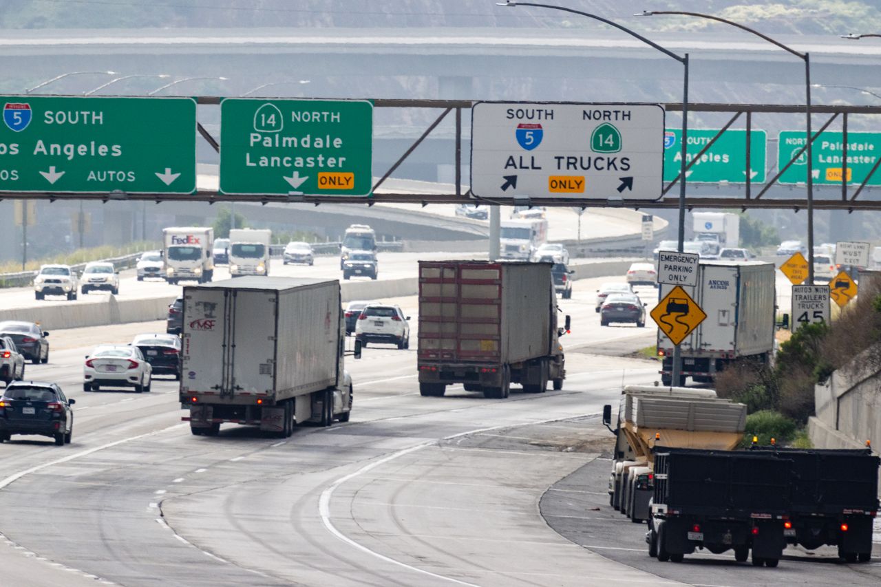 Trucks and cars traveling on a highway
